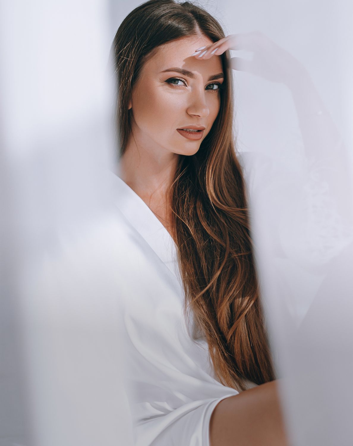 Woman in a white robe with long hair.