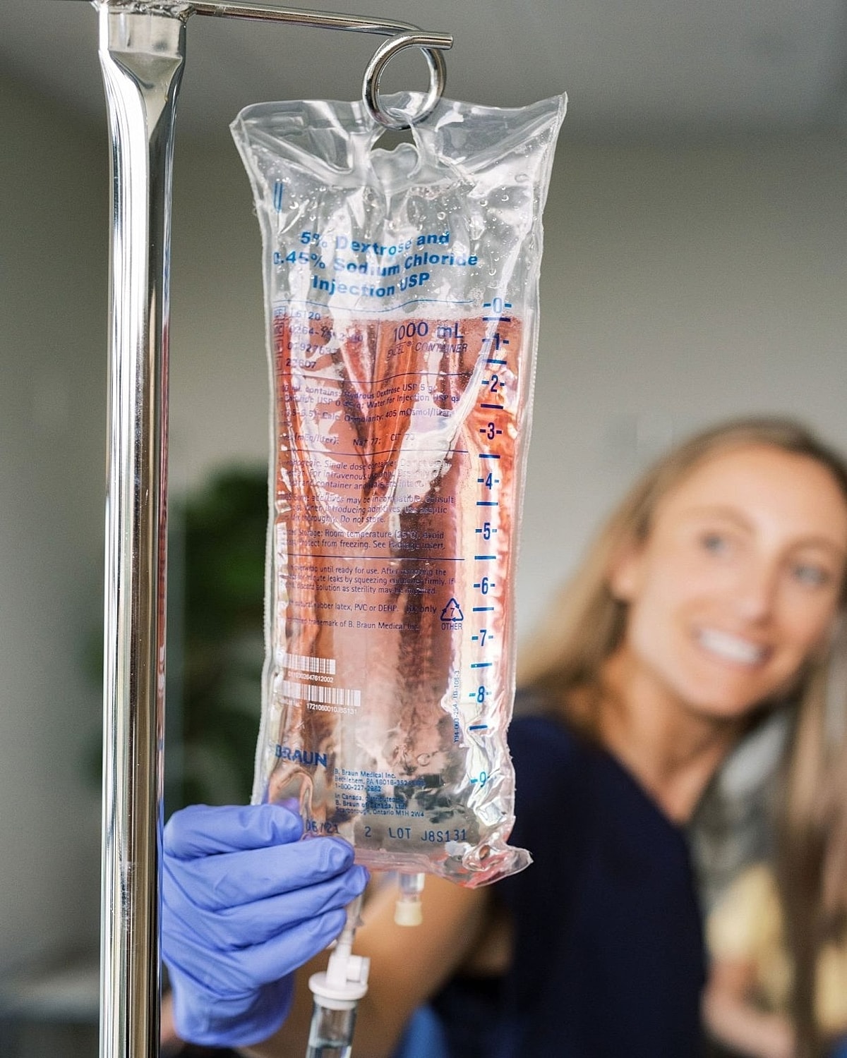 IV bag in medical setting with smiling patient.