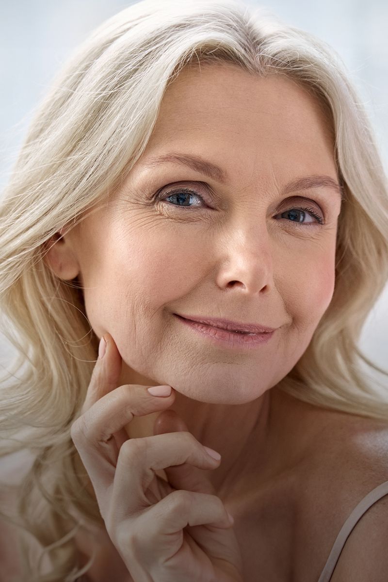 Smiling woman with long, light-colored hair.